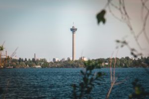 white and brown tower near body of water during daytime